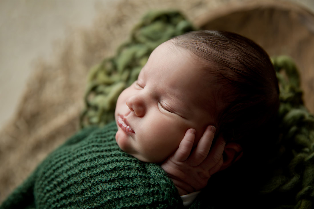 Sleeping baby boy in green 